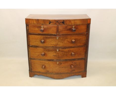 Regency mahogany and ebony line-inlaid bow front chest with two short over three long graduated drawers between barleytwist a