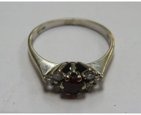 18ct WHITE GOLD RING SET WITH CLEAR STONES AND CENTRAL RUBY COLOURED STONE 