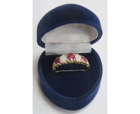 9ct GOLD DRESS RING SET WITH OPALS AND RUBY COLOURED STONES 