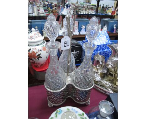 Three Bottle Glass Decanter Set, in plated triform stand with pierced bottle supports, 40cm high.