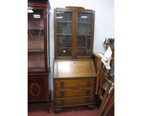 A XX Century Oak Bureau Bookcase, top with leaded glazed doors, bureau with a fall front, fitted interior, three long drawers
