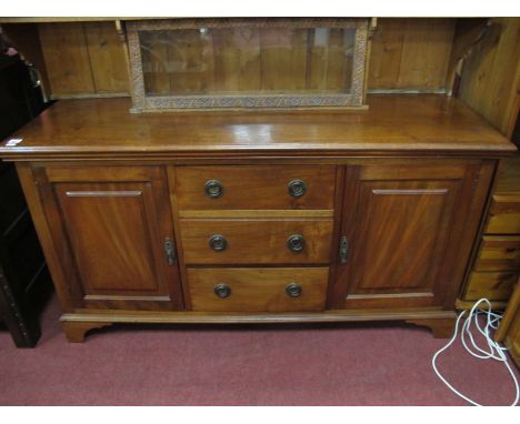 A XX Century Mahogany Cabinet, with three central drawers, flanking cupboards on bracket feet.