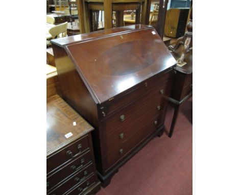 A XX Century Mahogany Bureau, with a fall front, fitted interior, three long drawers, on bracket feet.