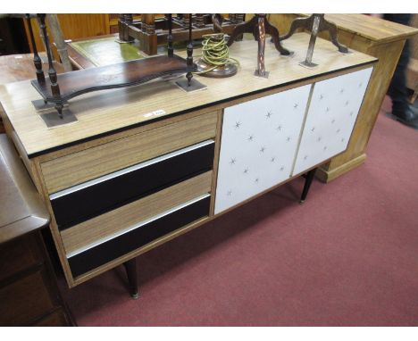 A 1960's Vintage Formica Sideboard, with four drawers, twin cupboard, with star decoration, on round black tapering legs, 152
