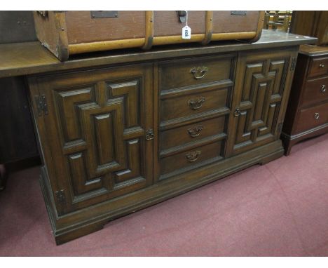 An Oak Sideboard, with three central drawers, with twin panelled doors, on bracket feet.