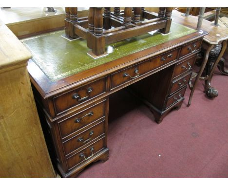 A XX Century Mahogany Pedestal Desk, top with a green leather scriver, three top drawers, pedestals with three drawers, on br