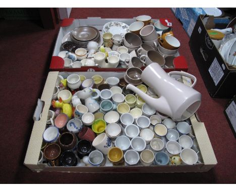 A Large Collection of Egg Cups, together with Poole tea cups, coffee cups and Poole Coffee Pot, etc:- Two Boxes.