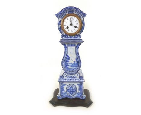 A late 19th century Blue and White Dutch Delft clock, with French barrel movement, on wooden base, with pendulum, 23.5 by 13.