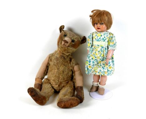 A late 1920s / early 1930s plush teddy bear, 44cm high, together with a 1940s Kammer &amp; Reinhardt celluloid doll, head no 