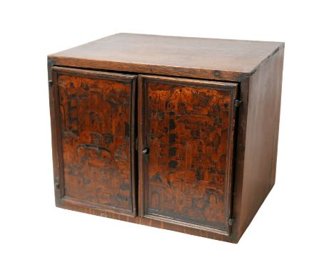 A 18th century oak and fruitwood inlaid table top cabinet, the two doors intricately inlaid with a design of buildings and ga