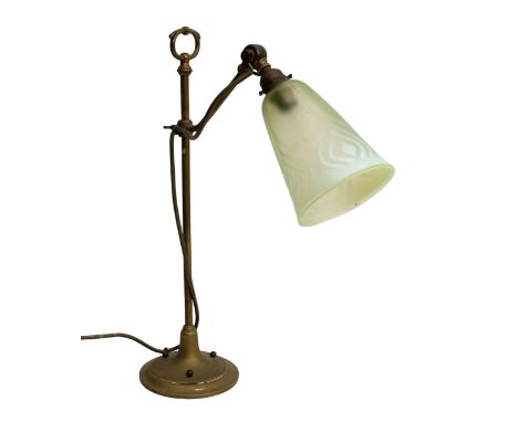 An Art Nouveau brass table lamp, with pale green glass shade, 12cm at opening, 50cm high. 