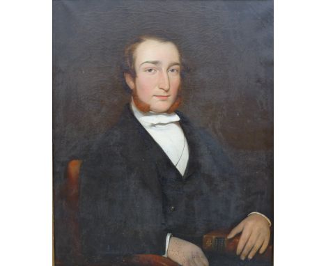 British School (19th century): a half length portrait of a gentleman, wearing a black coat and holding a bible, oil on canvas