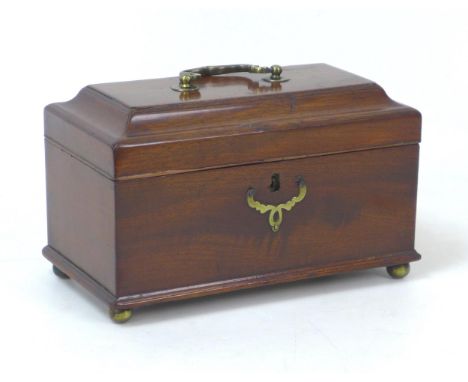 A Georgian mahogany tea caddy, with brass fittings and three compartments to its interior, raised upon four brass ball feet, 
