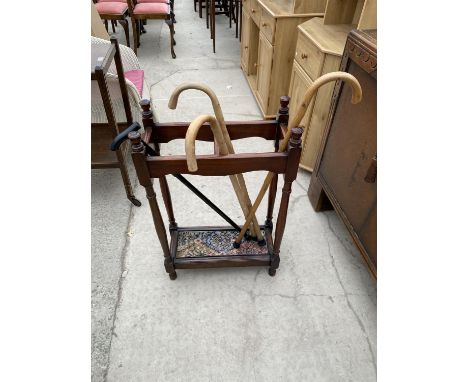 A MAHOGANY STICK STAND WITH DRIP TRAY AND WALKING STICKS 