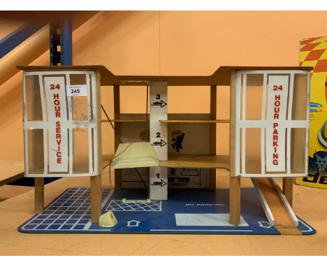 A VINTAGE WOODEN MULTISTORY MODEL CARPARK WITH A CAR LIFT 