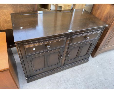 AN ERCOL SIDEBOARD ENCLOSING TWO DRAWERS AND TWO CUPBOARDS, 39" WIDE 