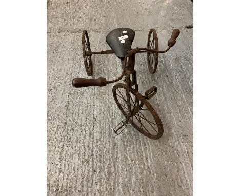 A VINTAGE WOODEN AND METAL CHILDS TRICYCLE 