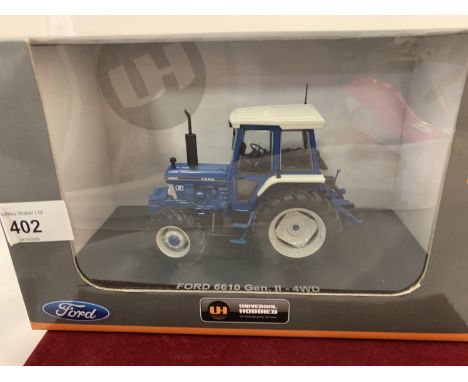 A UNIVERSAL HOBBIES DIE CAST FORD TRACTOR 1:32 