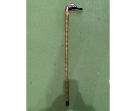 A GREEN WOODEN WALKING STICK WITH A PAINTED DRAKE'S HEAD HANDLE 