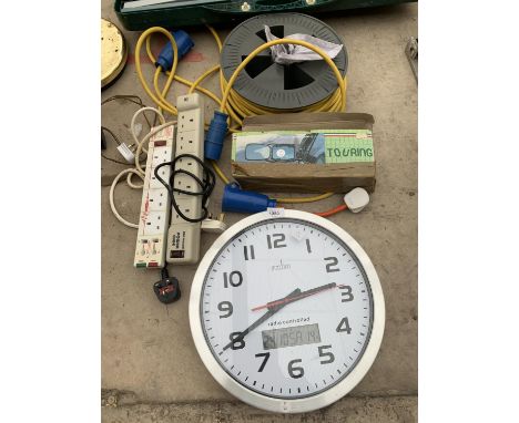 A LARGE RADIO CONTROLLED CLOCK, A 110V EXTENSION LEAD AND FURTHER EXTENSION LEADS 