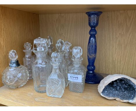 A COLLECTION OF SCENT OR VINEGAR BOTTLES AND A COBALT BLUE CANDLE STICK 