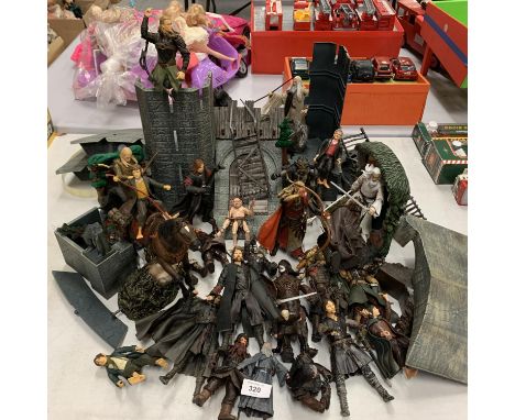 A COLLECTION OF LORD OF THE RINGS ACTION FIGURES INCLUDING HELMS DEEP AND ACCESSORIES 