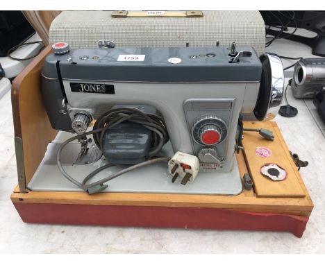 A VINTAGE JONES SEWING MACHINE AND CASE 