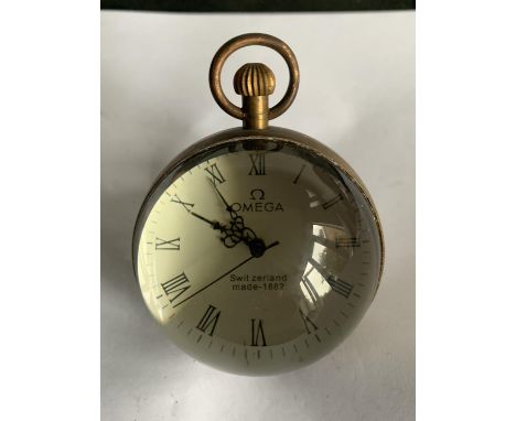A BRASS AND GLASS BUBBLE CLOCK IN WORKING ORDER 