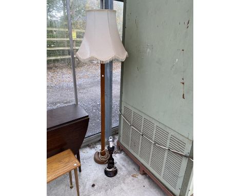 AN OAK STANDARD LAMP COMPLETE WITH SHADE, AND A CARVED MAHOGANY TABLE LAMP 