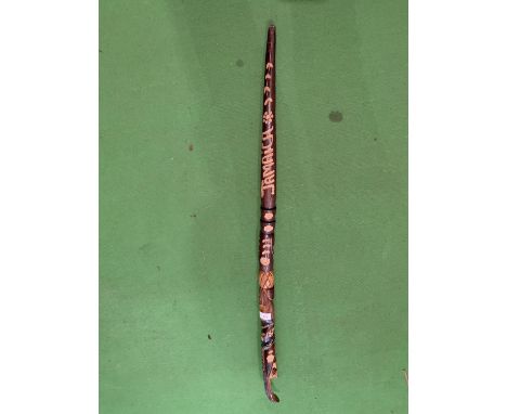 A WOODEN SNAKE HANDLE WALKING STICK WITH ORNATE CARVING 