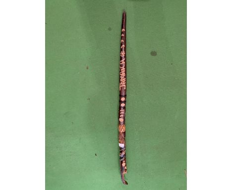 A WOODEN SNAKE HANDLE WALKING STICK WITH ORNATE CARVING 