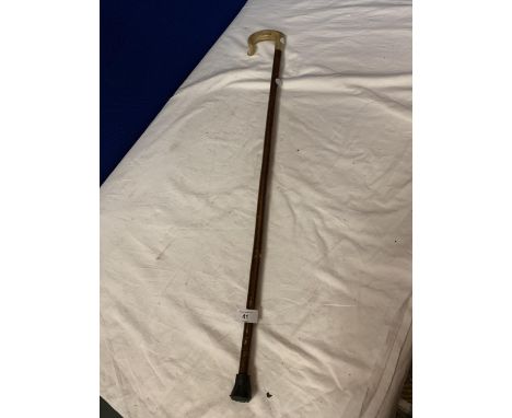 A WOODEN WALKING STICK WITH ANIMAL HORN HANDLE 