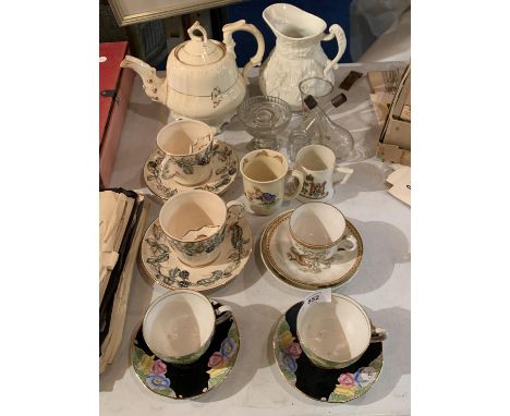 A COLLECTION OF TEAWARES TO INCLUDE A TEAPOT, LARGE JUG, SEVERAL CUPS AND SAUCERS AND SOME GLASS 