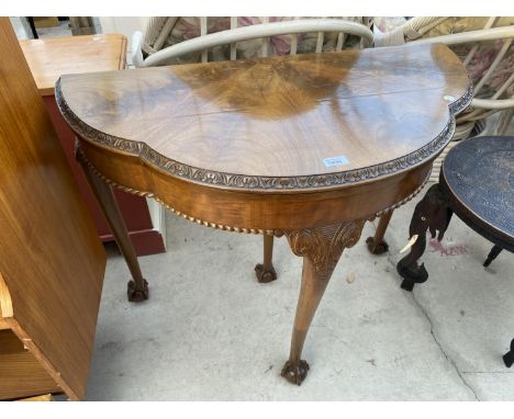 A REPRODUCTION MAHOGANY DEMI-LUNE FOLD-OVER CARD TABLE ON CABRIOLE LEGS AND BALL AND CLAW FEET, 36" WIDE