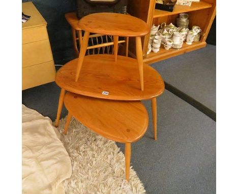 An Ercol (354) pebble nest of three tables in elm and beech and an Ercol Windsor magazine rack/table combination