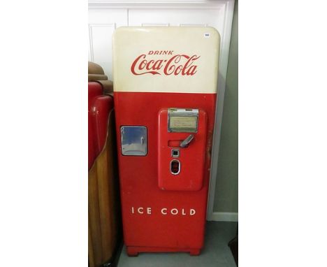 A 1950s enamel Coca Cola vending machine with cream and red door
