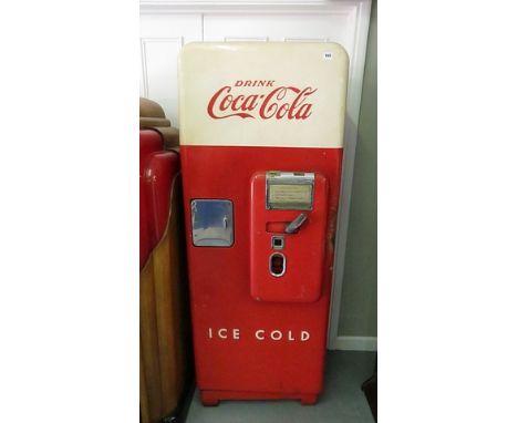 A 1950s enamel Coca Cola vending machine with cream and red door