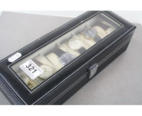 Six vintage Swiss manual wind gents watches in a display case 