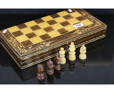 A contemporary boxed chess  set with integral board.