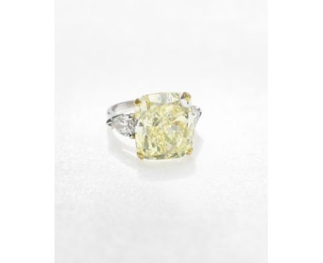 GRAFF: FANCY COLOURED DIAMOND AND DIAMOND RINGThe cushion-shaped Fancy Light Yellow diamond, weighing 17.30 carats, between p