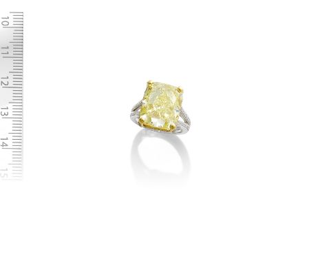 FANCY COLOURED DIAMOND AND DIAMOND RINGThe cushion-shaped Fancy Yellow diamond, weighing 14.03 carats, in a bicoloured settin