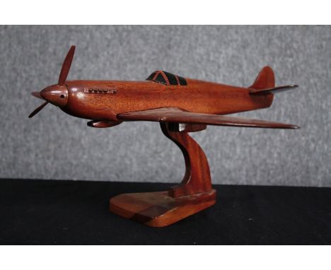 A large carved Supermarine Spitfire. Desk model. Missing one blade to its propeller and one exhaust funnel but otherwise in g