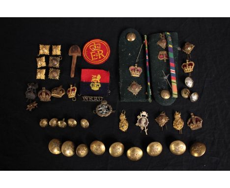 A mixed collection of military brass buttons, badges, epaulettes and medal ribbons. Includes a badge from the Women's Royal A