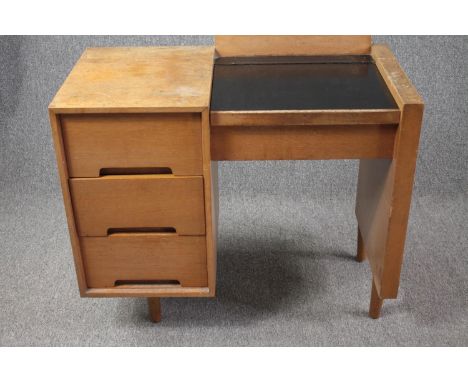 A mid century light teak dressing table by John and Sylvia Reid for Stag Furniture fitted with rising vanity mirror. H.80 W.8