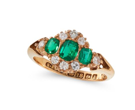 AN ANTIQUE EMERALD AND DIAMOND RING, 1910 in 18ct yellow gold, set with three graduated step cut emeralds totalling 1.98 cara