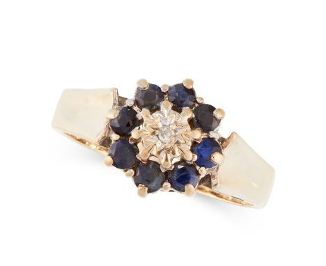 A SAPPHIRE AND DIAMOND RING in yellow gold, set with a round cut diamond in a cluster of round cut sapphires, stamped 375, si