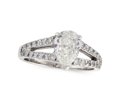 A SOLITAIRE DIAMOND DRESS RING in platinum, set with a central pear cut diamond of 1.01 carats, on a bifurcated band set with