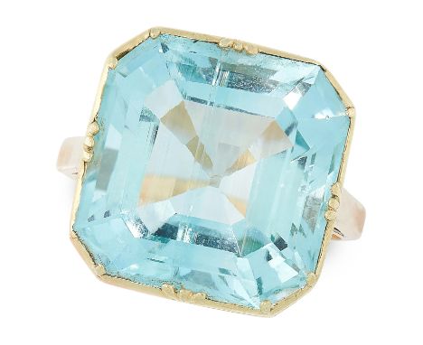 AN AQUAMARINE DRESS RING in yellow gold, set with an emerald cut aquamarine of 14.38 carats, size N / 6.5, 5.9g.