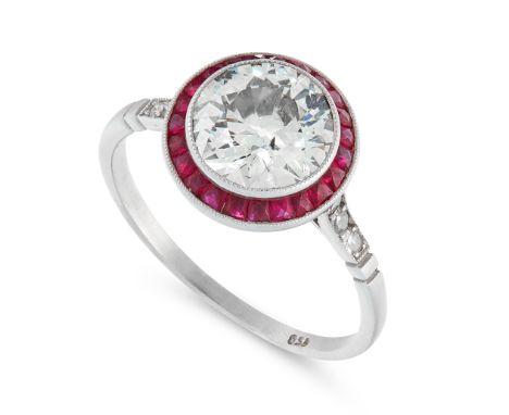 A DIAMOND AND RUBY TARGET RING in Art Deco design, in platinum, set with a central old European cut diamond of 1.82 carats in