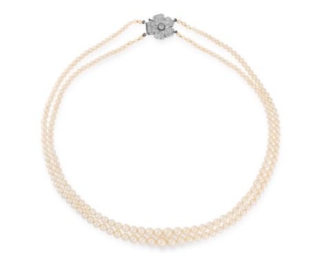A PEARL AND DIAMOND NECKLACE, CIRCA 1955 in platinum, comprising two rows of graduated pearls ranging from 7.2mm to 2.9mm, on